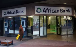 In Cape Town, on August 8, 2014, a janitor passes by an African Bank branch.